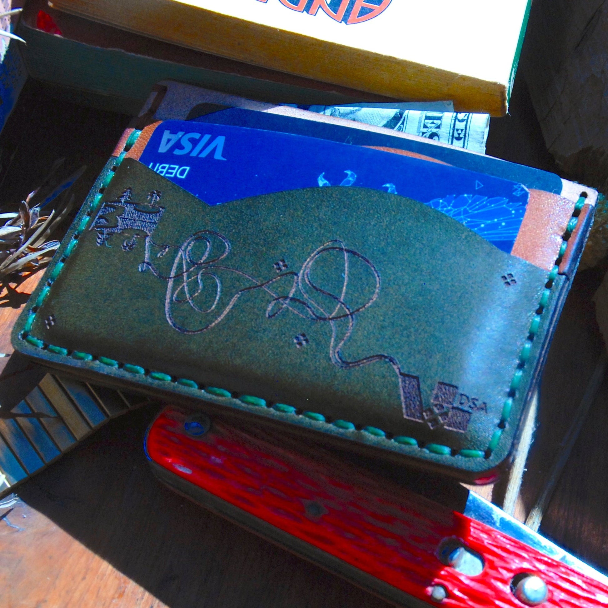 Unique minimalist wallet with five slots.  Variant 1. Sown by hand. Made with full grain vegetable-tanned leather. Alternative Front view with cards.